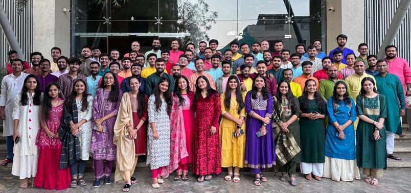 The Aakash team, many in festive dress, gathered on the steps outside the office.
